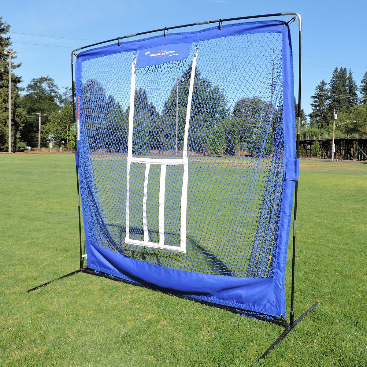 The JUGS Complete Practice Travel Screen with its flip-over strike zone set up on a grass field.