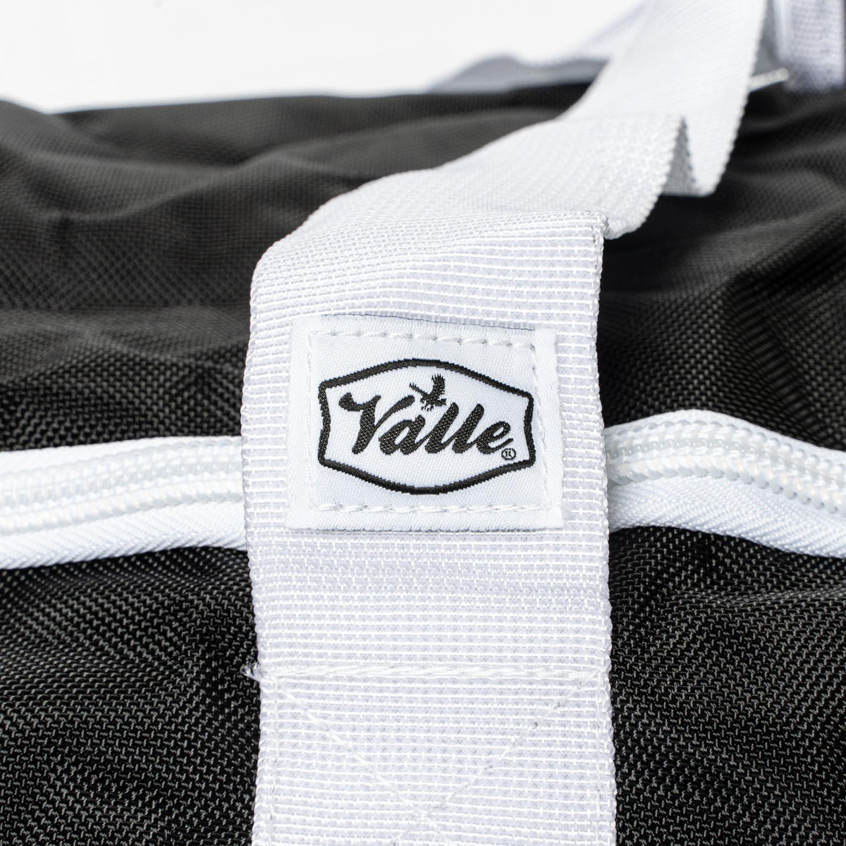 Stitched Valle tab on the white strap of the black Catchers Duffle