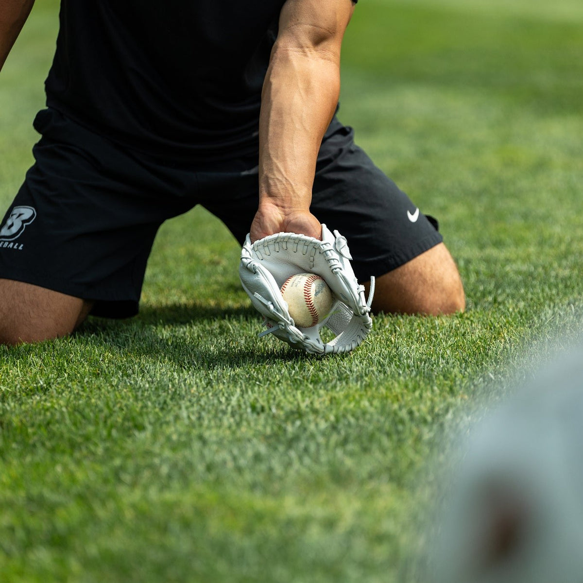 Valle Eagle K47 infield training glove, a player fielding a ground ball on grass with the glove