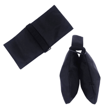 A folded black sand bag beside a second bag laid open.