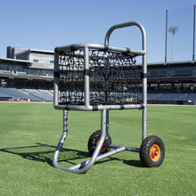 low angle picture of baseball ball cart in center field grass and stadium behind