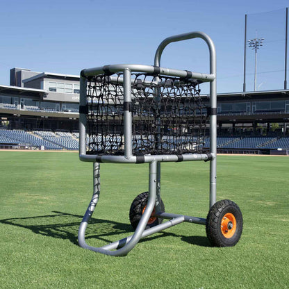 low angle picture of baseball ball cart in center field grass and stadium behind