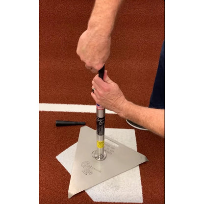 A pair of hands using the cup cutter to slice a rubber cup from a tee upright.