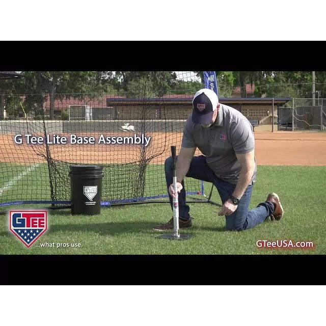 A player using the G Tee Lite Low Ball Tee on a practice field, with G Tee branding across the frame.