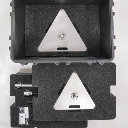Two foam inserts lifted out of the G Tee transport case, each cut with a triangular recess.