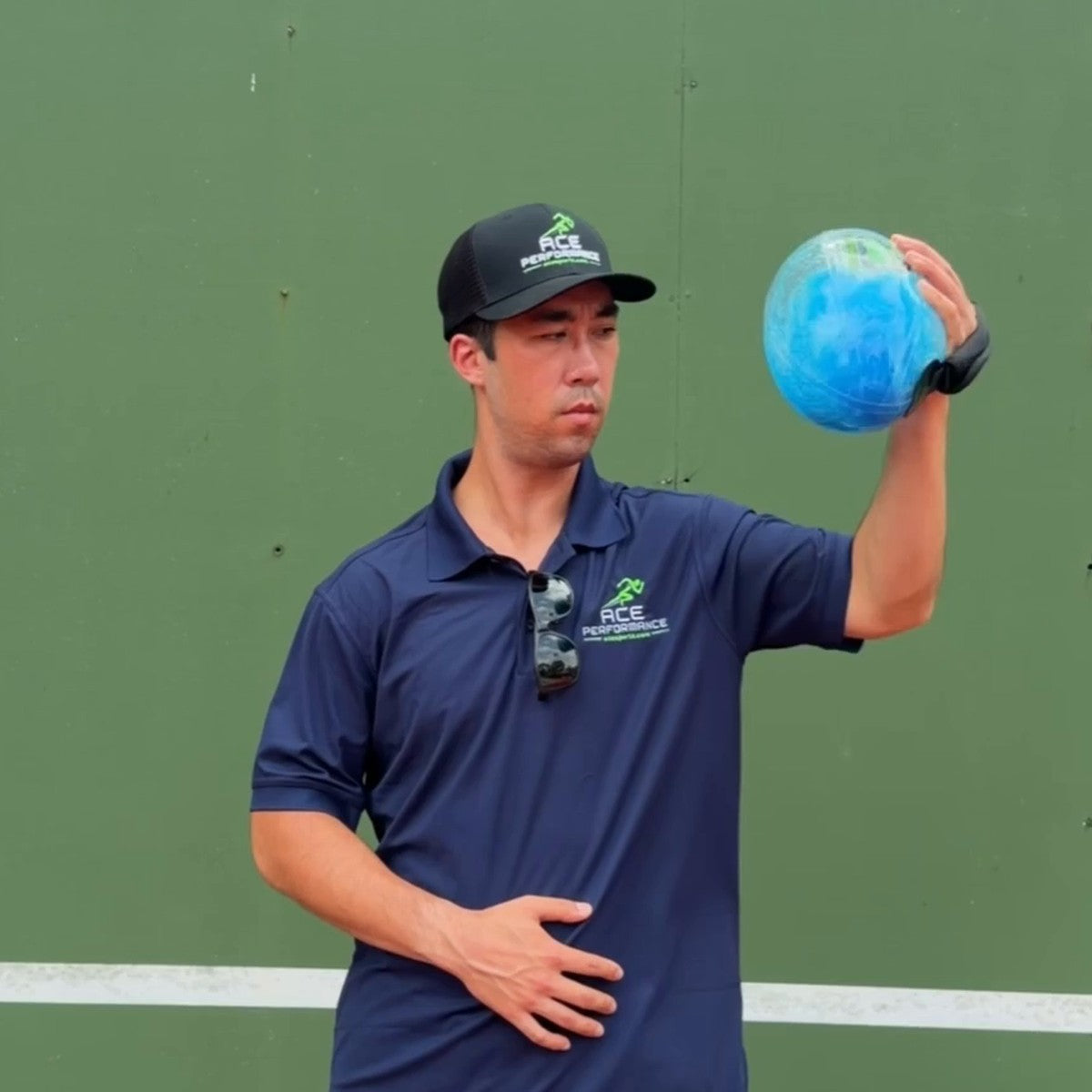 Player holding the water football up with the upper arm out at 90 degrees for a rotator cuff exercise