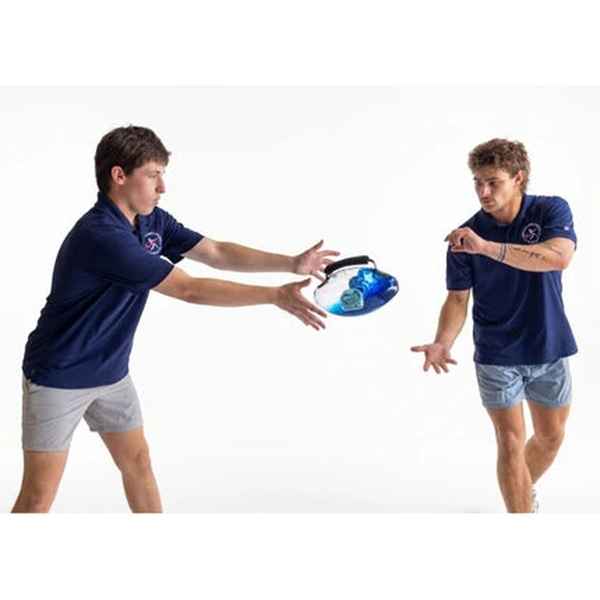 Two players making a short partner toss with the water-filled training football
