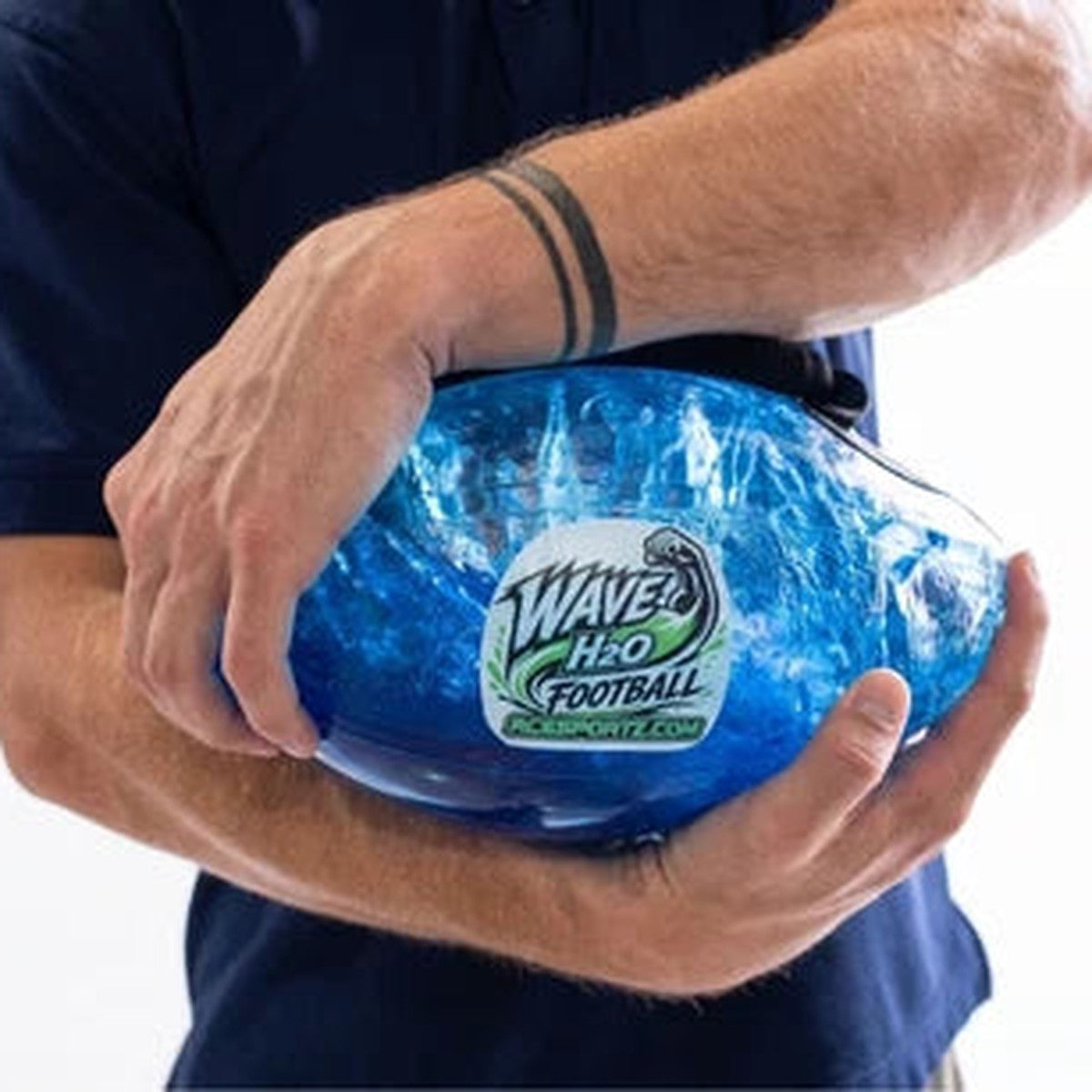 Player hugging the water-filled football against his body with the blue water swirling inside the clear shell