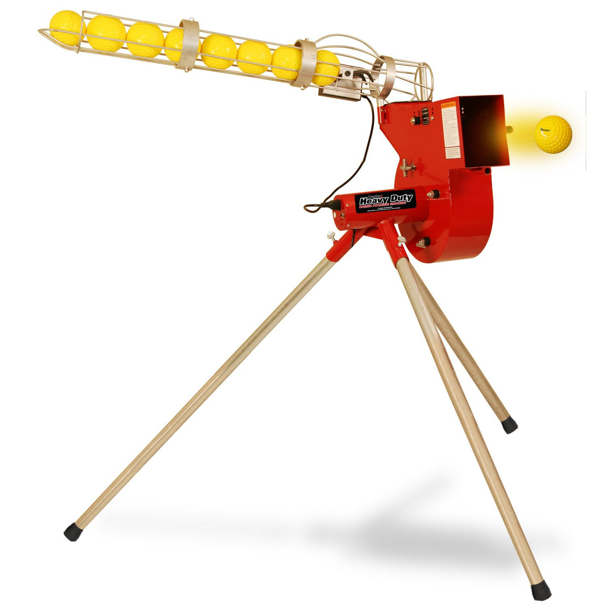 A red Heater Combo pitching machine on wooden-look tripod legs with a clear tube ball feeder full of yellow balls, one ball leaving the machine.