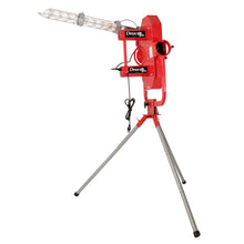 A red Deuce dual-wheel pitching machine on a silver steel tripod, with a clear tube ball feeder angled up from the top, on a white background.