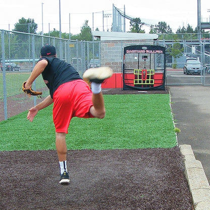 A pitcher throwing toward the JUGS Backyard Bullpen screen in a backyard bullpen area.