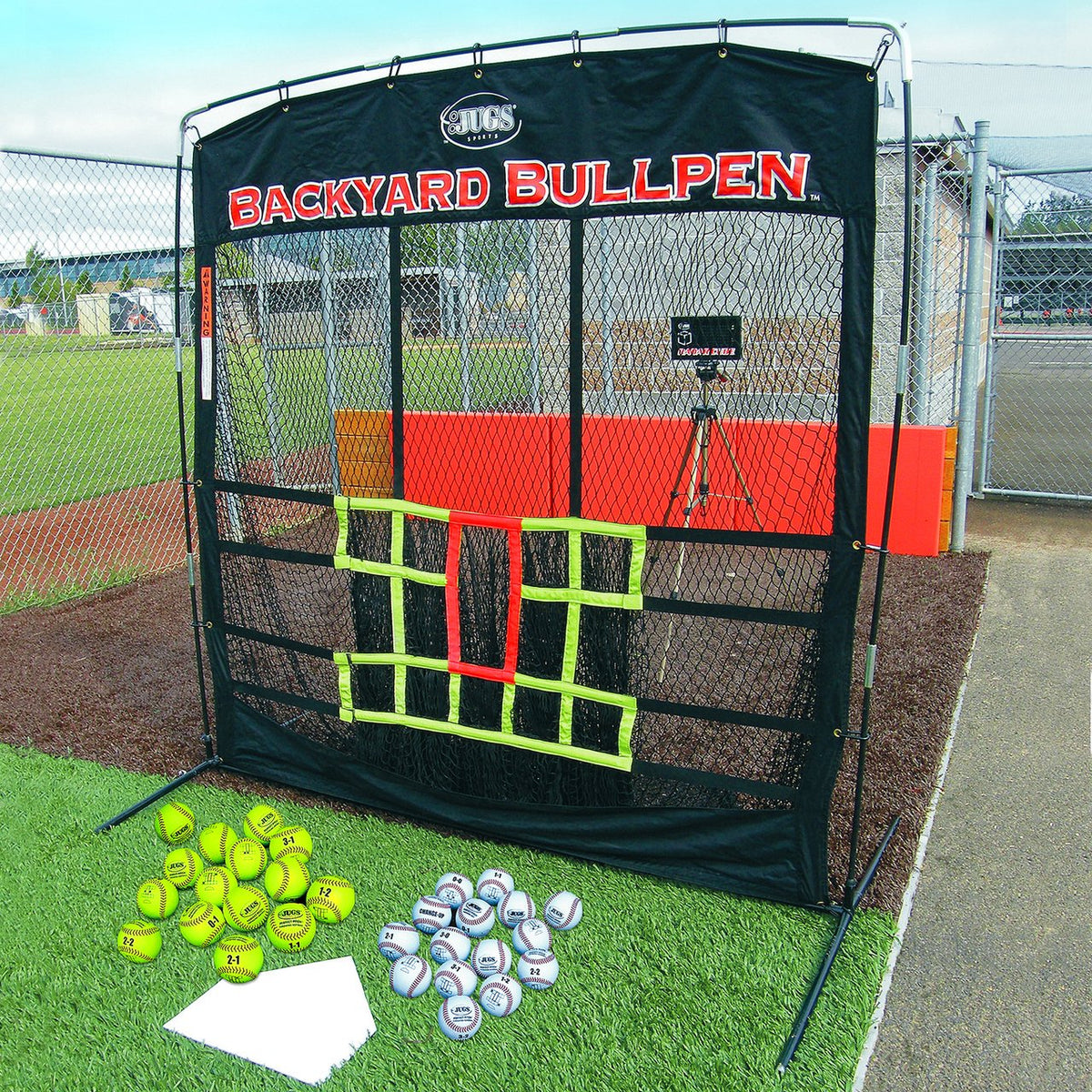 The JUGS Backyard Bullpen screen with its 12 marked target zones, Radar Cube, throw-down plate and marked training balls set up outdoors.