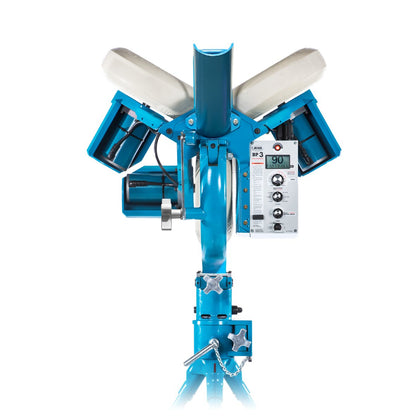 Front view of the light blue JUGS BP3 three-wheel baseball pitching machine with its three white wheels, black ball chute and control panel, standing on a tripod base, photographed on a white background.