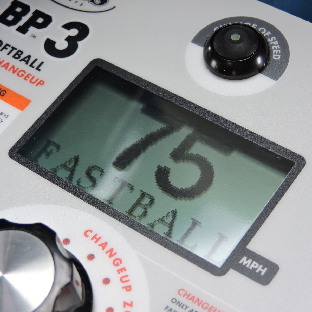 Close-up of the JUGS BP3 softball control panel with the digital readout showing 75 fastball and the changeup zone dial.