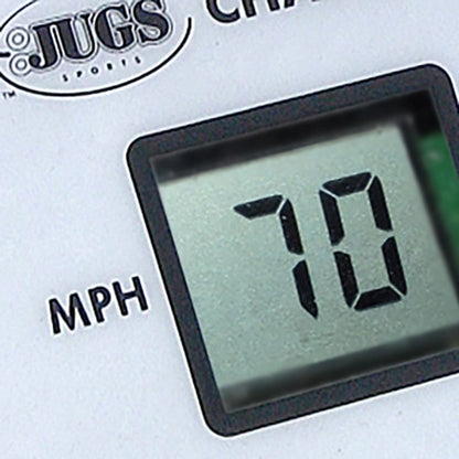 A close-up of a digital display on a JUGS pitching machine control panel reading 70 MPH.