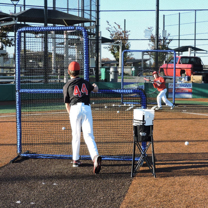 A youth pitcher throwing batting practice from behind the JUGS Protector Blue Series L-Shaped Pitchers Screen.