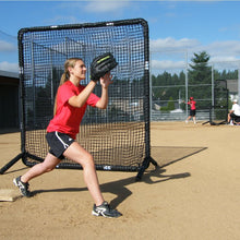 A softball fielder catching a throw in front of the JUGS Protector Series Square Baseman Screen.