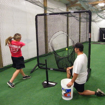 A coach soft tossing to a softball player hitting into the JUGS Protector Series Square Screen with Sock-Net.