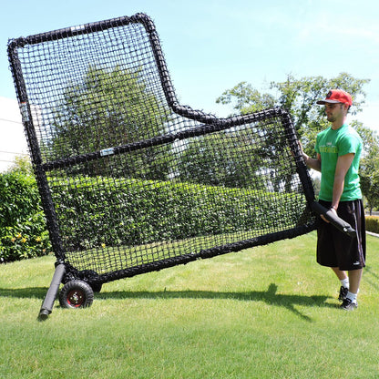 A man tilting a JUGS Protector Series L-Shaped Screen onto its wheel kit to roll it across grass.