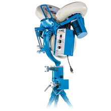 Side view of the JUGS SP3 baseball pitching machine on its tripod, showing the control box, power cord and wheels, photographed on a white background.