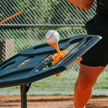 The ball topper on the Swing Path Trainer holding a baseball.