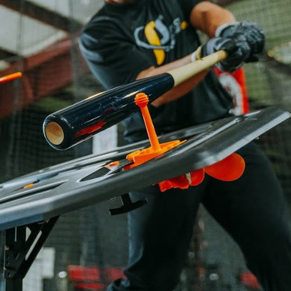 The Dry Swing Tee Topper mounted on the Swing Path Trainer during a cage session.
