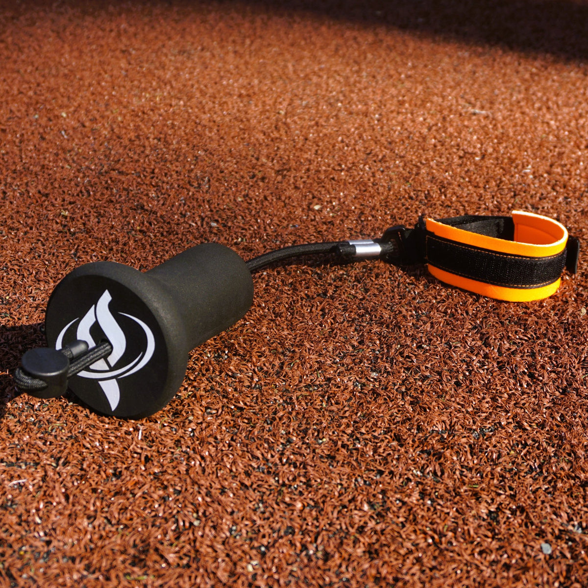 The True Connect band and foam attachment lying on infield dirt.