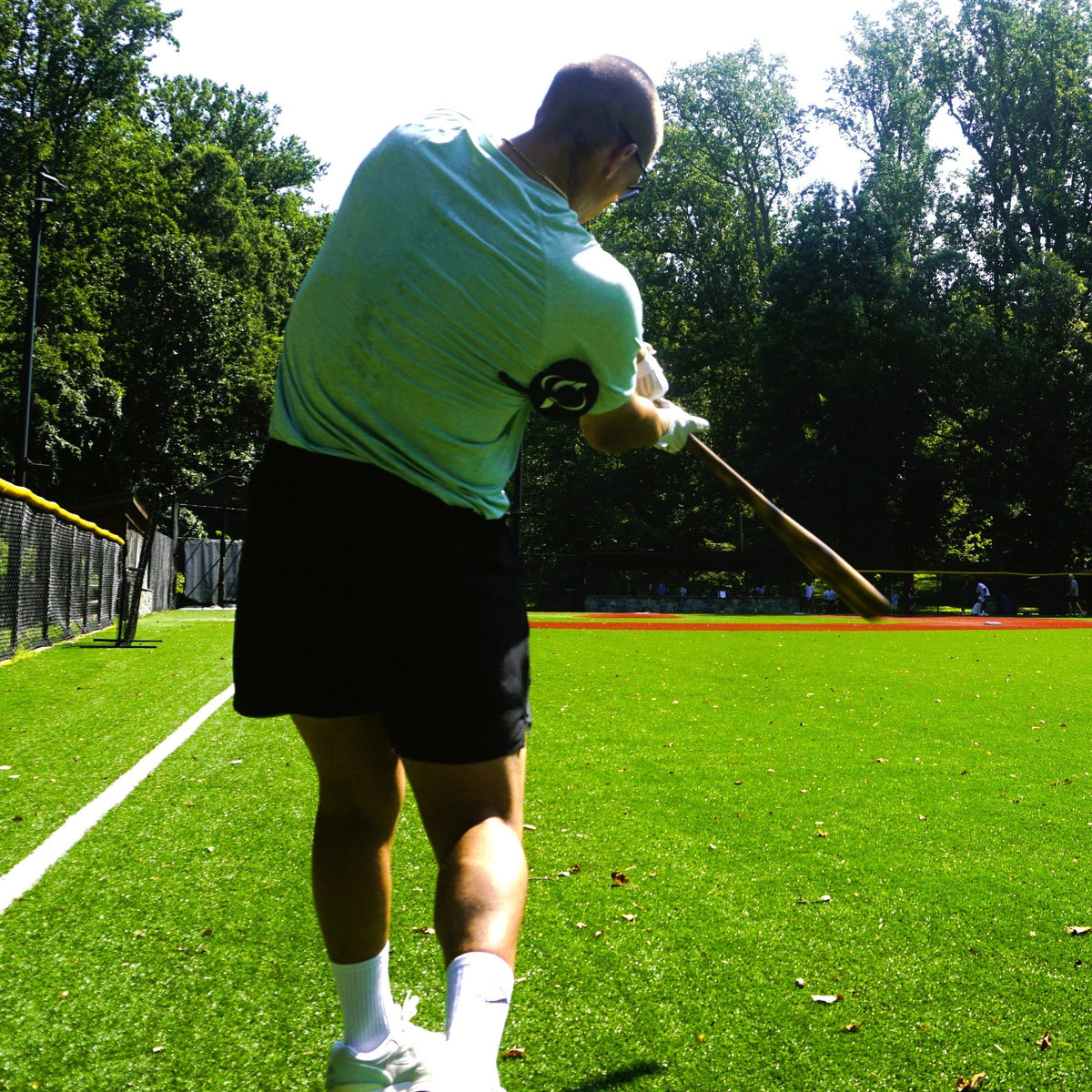 A hitter mid-swing on a field while wearing the True Connect.
