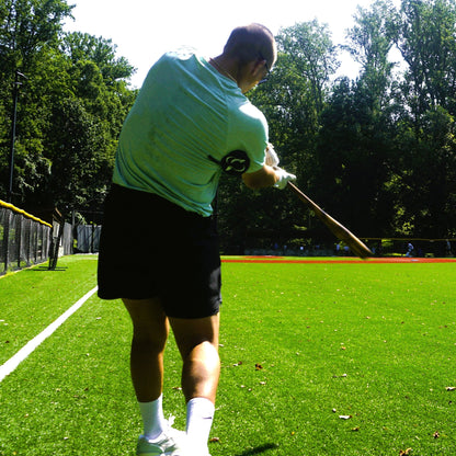 A hitter mid-swing on a field while wearing the True Connect.