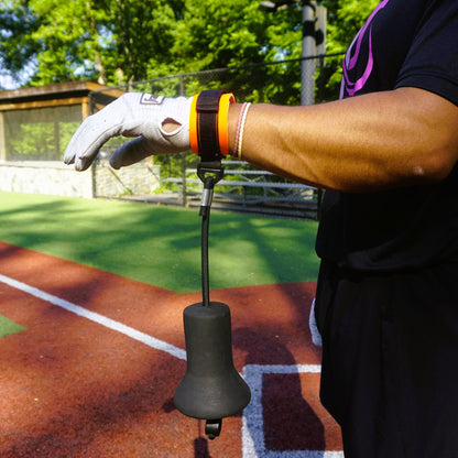 A hitter wearing the True Connect takes a swing off a training tee.