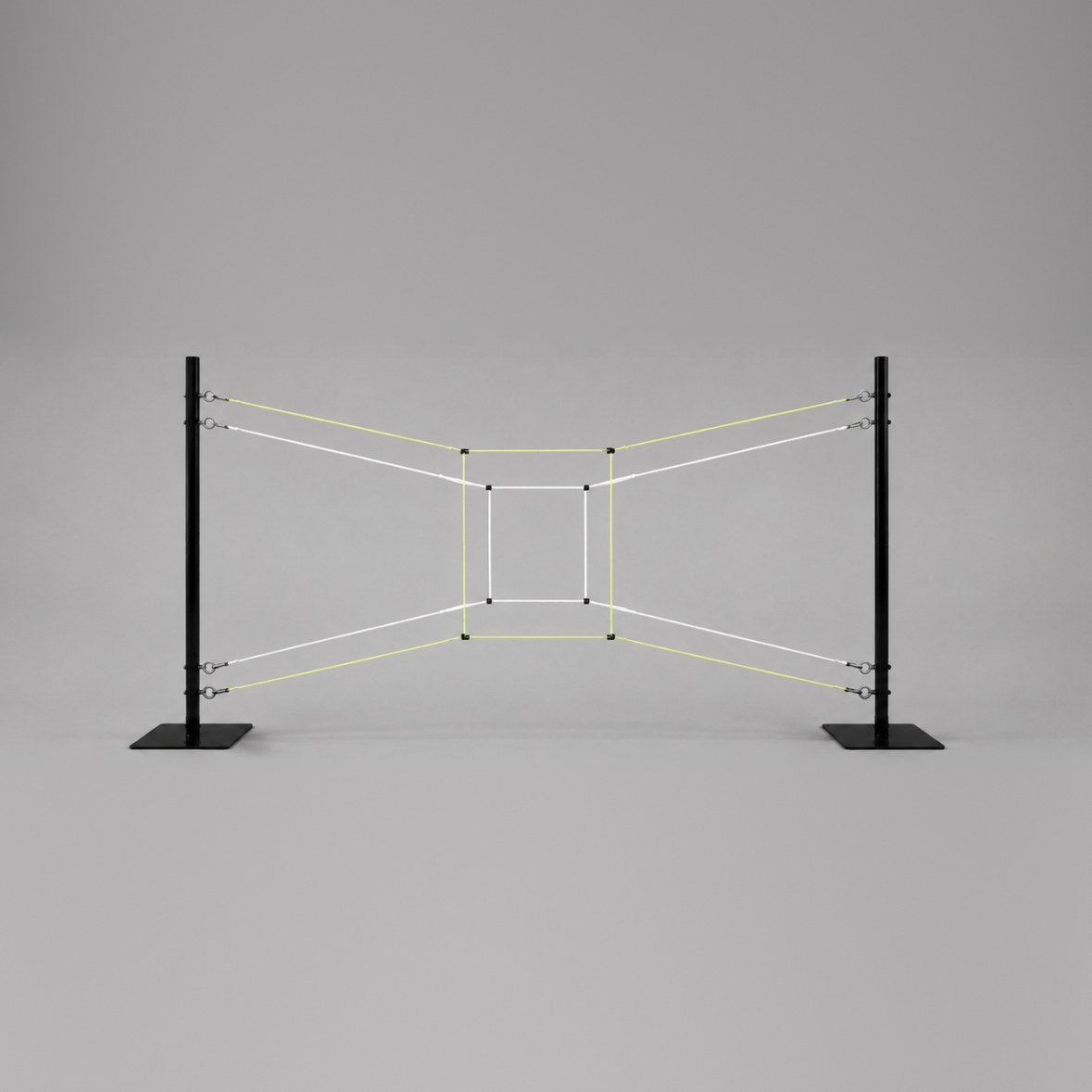 Two black poles on flat bases holding white and yellow strings that form a small rectangle inside a larger one