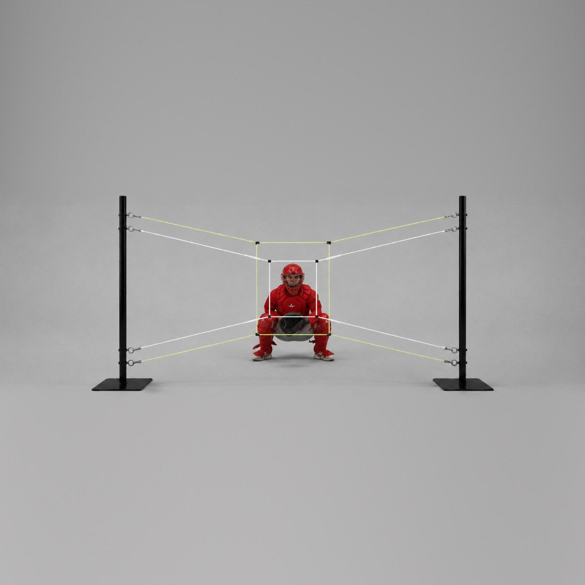 A catcher in red gear crouched behind the string target, framed by the inner white rectangle and the outer yellow rectangle