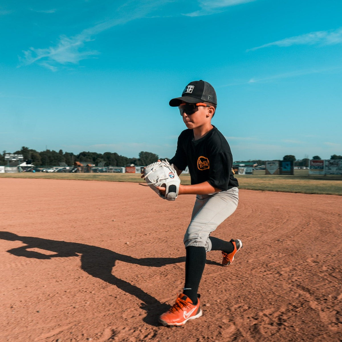 Valle Eagle 8S infield training glove, a youth player fielding on a dirt infield with the glove
