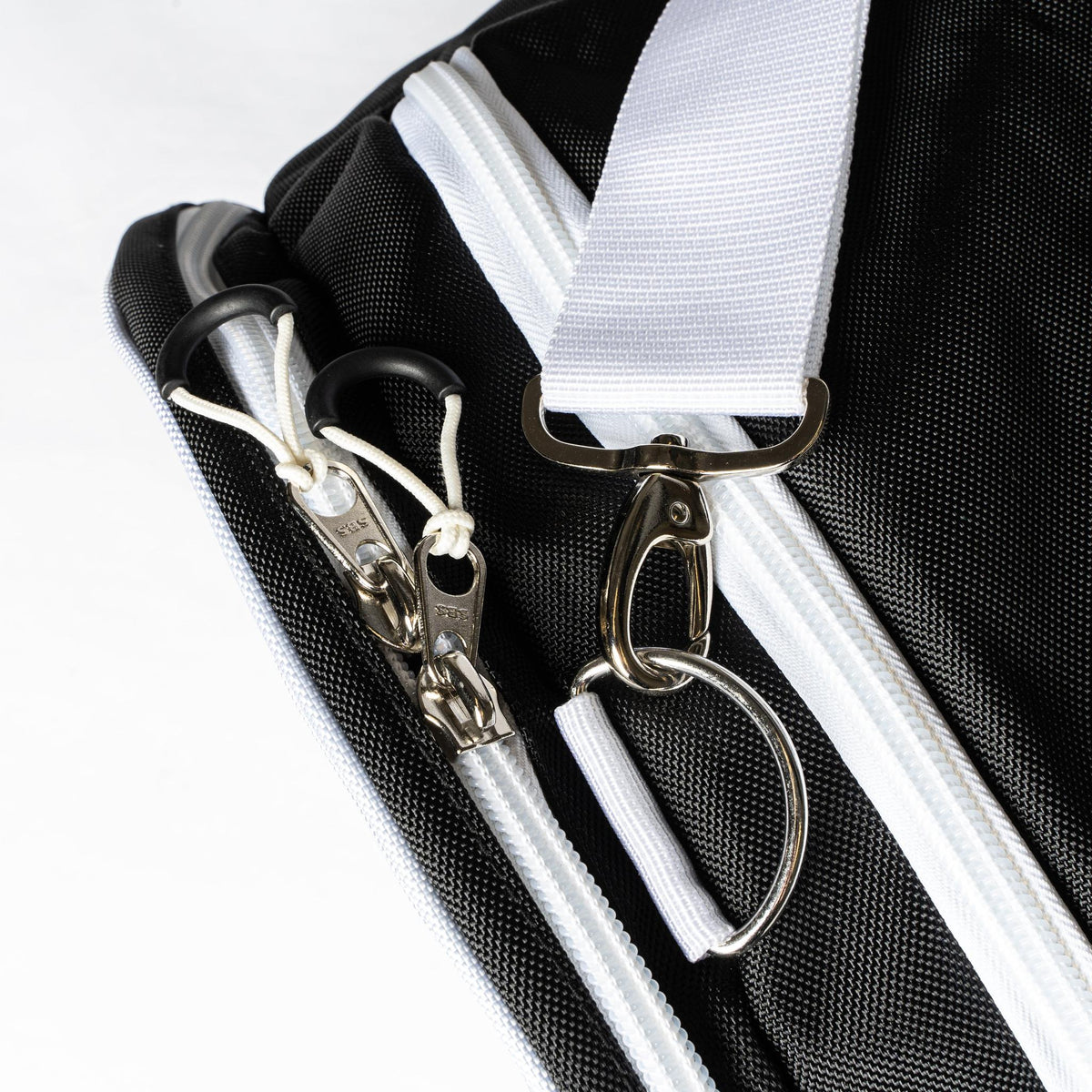 Dual corded zipper pulls and shoulder strap clip on the black Valle Eagle Ball Bag