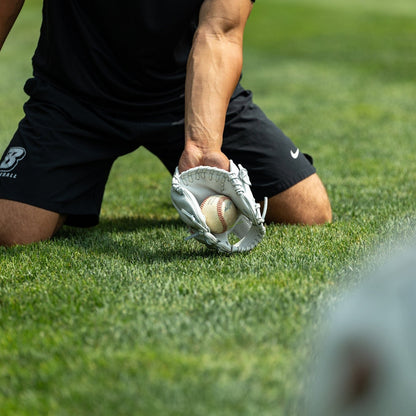 Valle Eagle K47 infield training glove, a player fielding a ground ball on grass with the glove