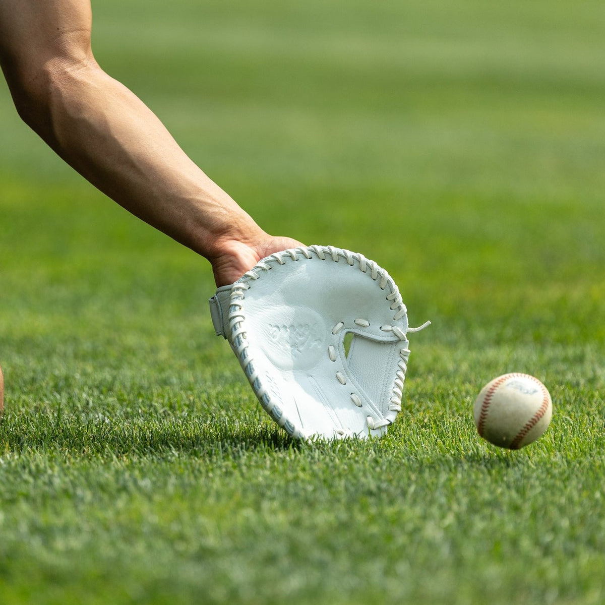 Valle Eagle KK four-finger training glove, a player fielding a ground ball with the flat glove