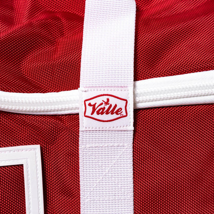 Stitched Valle tab where the white strap crosses the red 1680 denier fabric of the Players Duffle