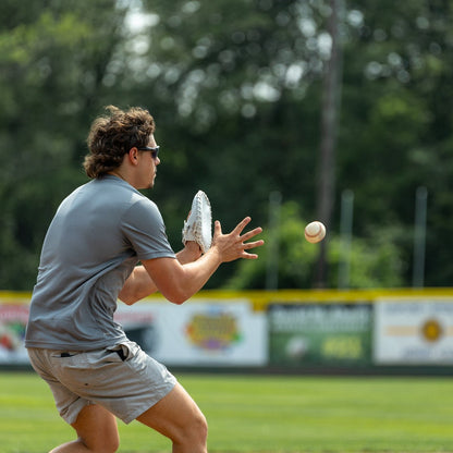 Valle Eagle Switch pancake training glove, a player throwing on a field while wearing the pancake glove