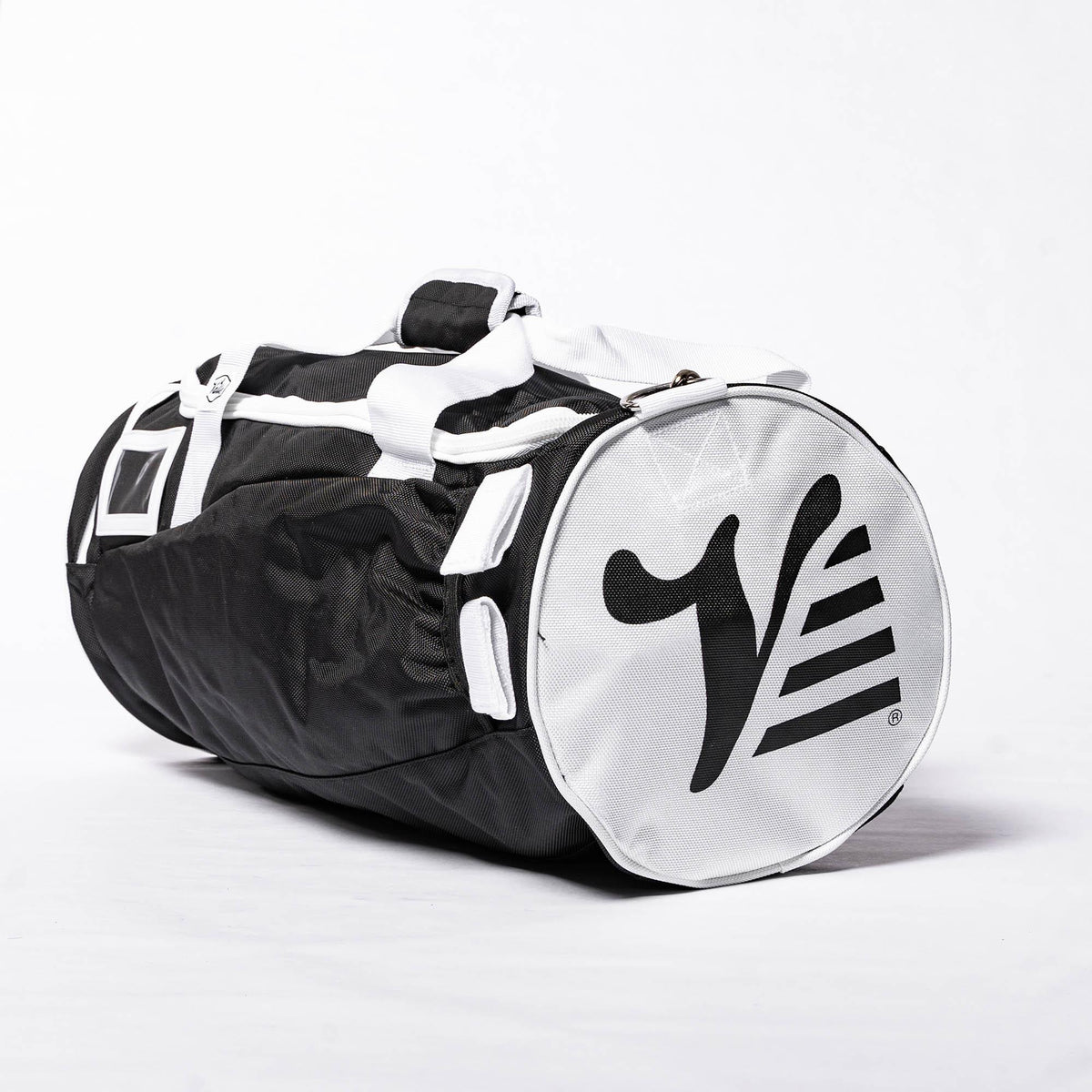 Black Valle Eagle Youth Equipment Bag, three quarter studio view with white end cap and straps