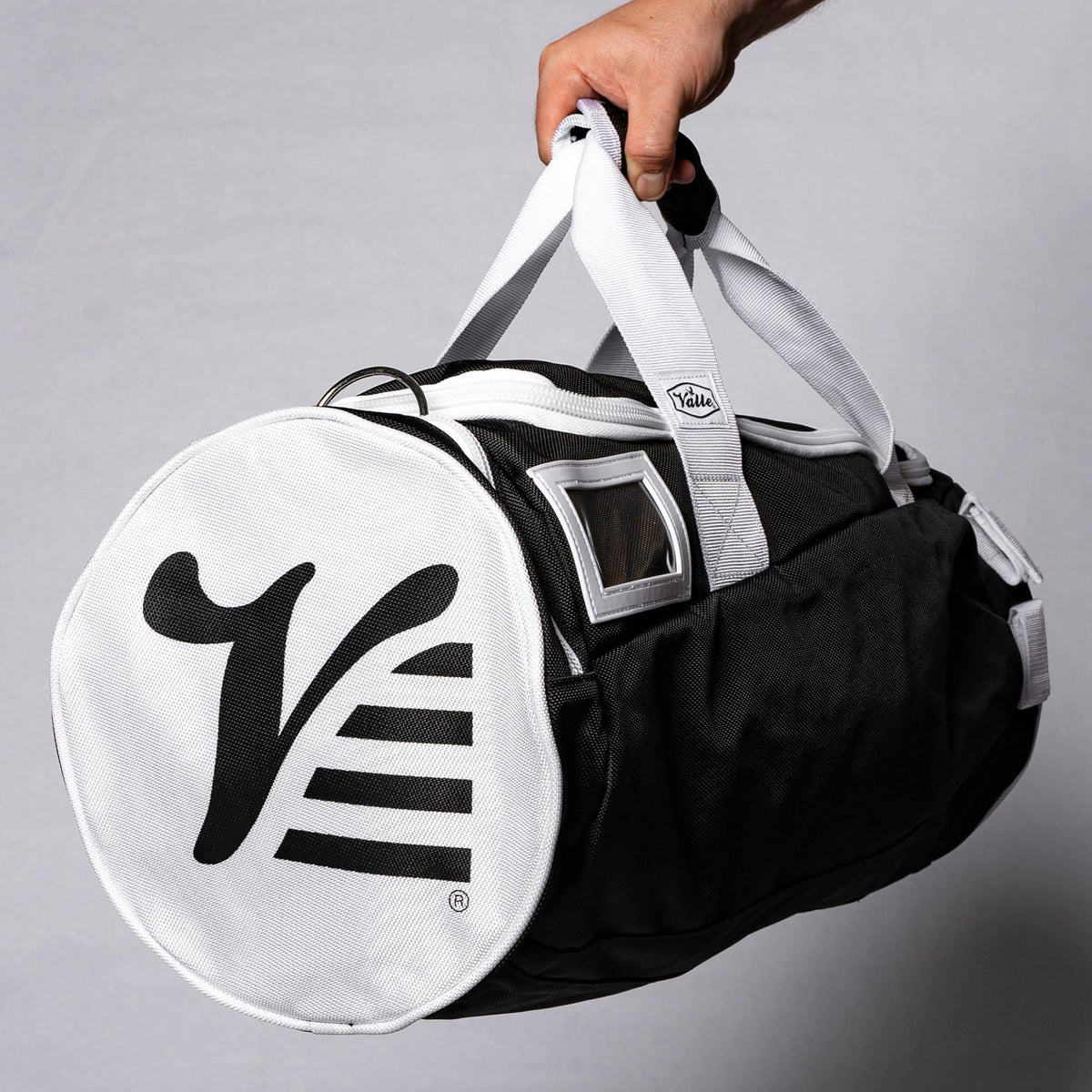 Black Valle Eagle Youth Equipment Bag held at an angle, showing the clear ID window and logo end cap