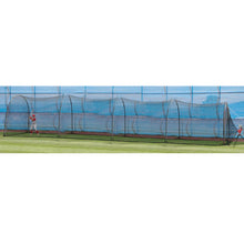 A long black netted backyard batting cage on a green lawn, seen from the side.
